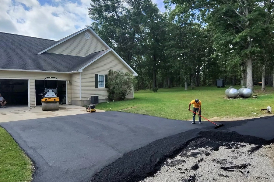 Bomag paver installing asphalt on the upper portion of a Salem, MO driveway