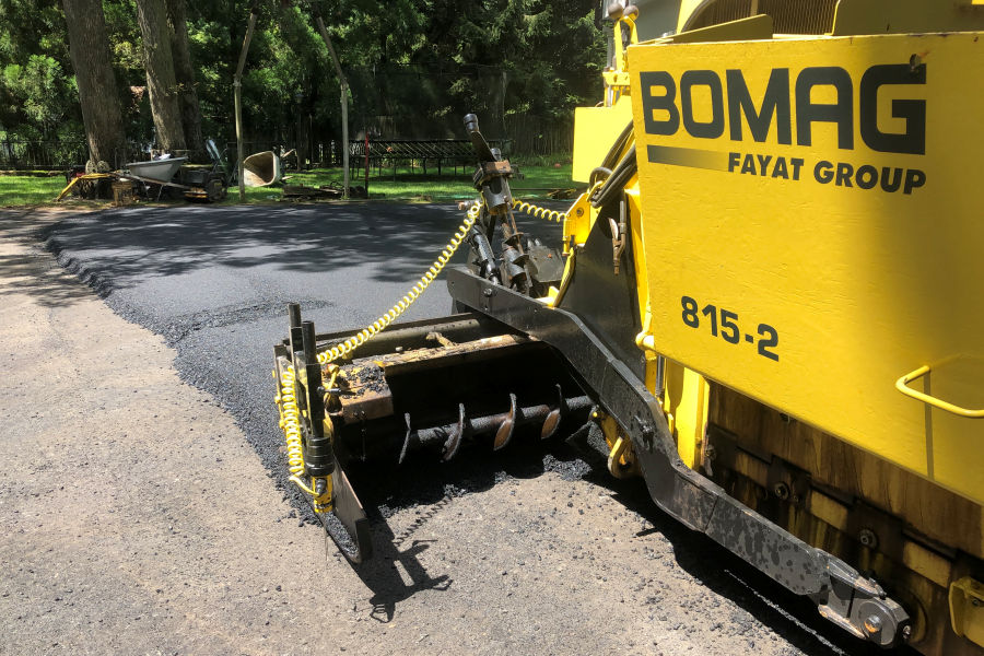 Titan’s BOMAG 815 asphalt paver equipped with a computerized sonic grading system