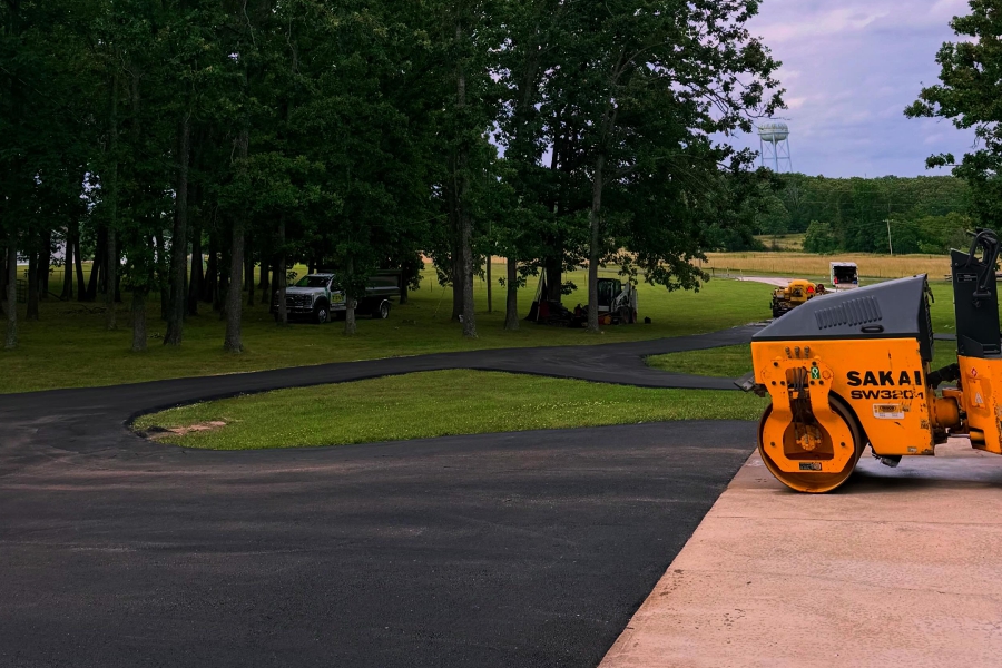 Curved asphalt circle driveway being paved at a Salem, Missouri home
